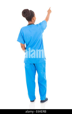 rear view of African American nurse pointing empty space Stock Photo