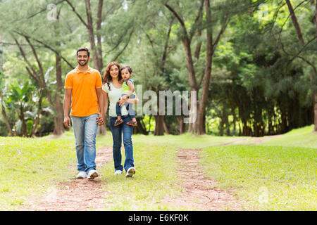 happy young Indian family going for a walk in forest Stock Photo