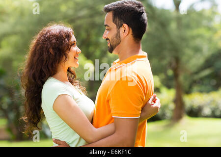 romantic young Indian couple hugging outdoors in forest Stock Photo