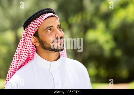 handsome middle eastern man looking up outdoors Stock Photo