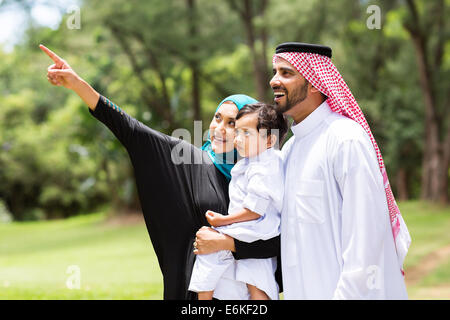 cute Arabian family looking and pointing in the forest Stock Photo