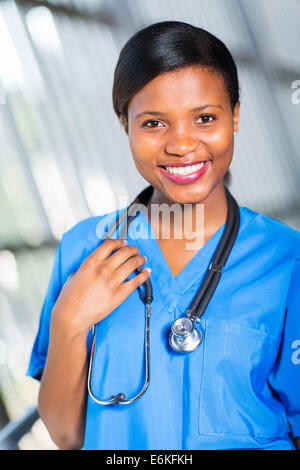 joyful attractive doctor in blue robe holding tablet and listening to ...