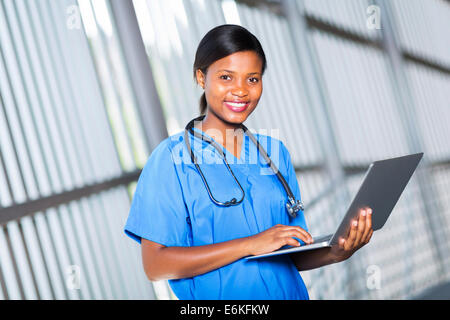 portrait of pretty afro American doctor using laptop computer Stock Photo