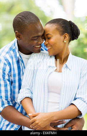 adorable African couple hugging outdoors Stock Photo