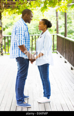 lovely African American couple holding hands outdoors Stock Photo