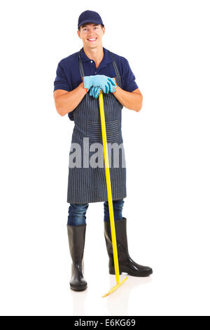 full length portrait of young male gardener with a rake Stock Photo
