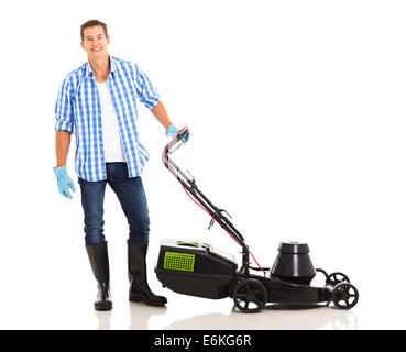 good looking man standing next to an electric lawnmower on white background Stock Photo