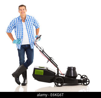 young man standing next to lawnmower on white background Stock Photo