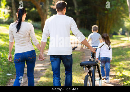 rear view of young family walking outdoors Stock Photo