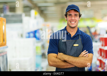 happy young salesman standing in hardware store Stock Photo