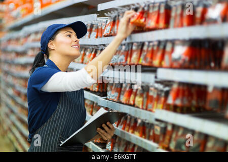 attractive hardware store worker counting stock Stock Photo