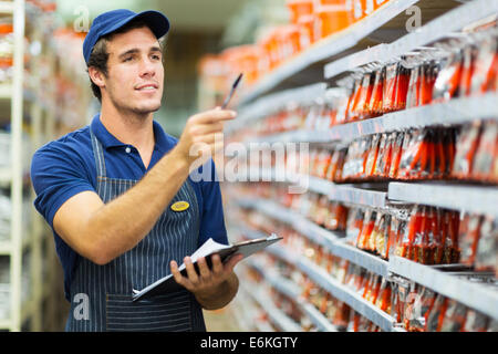 good looking hardware store worker counting stock Stock Photo