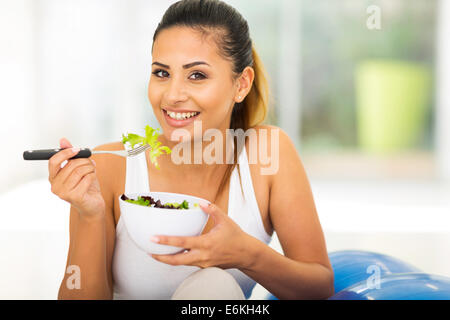 healthy young woman eating green salad Stock Photo