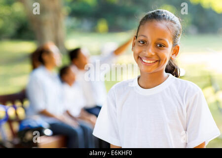 beautiful Indian little girl standing in front of family outdoors Stock Photo
