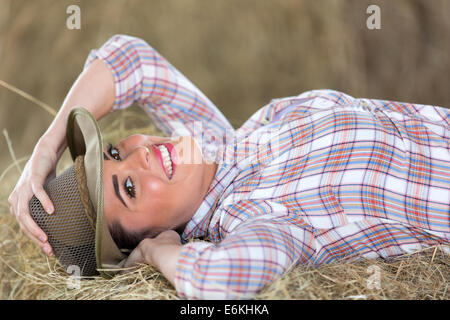 happy cowgirl lying on hay Stock Photo