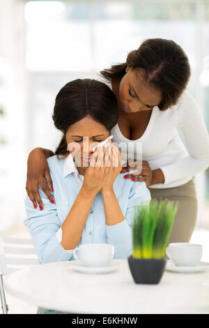 caring African woman comforting crying mother Stock Photo