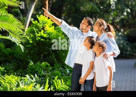 beautiful Indian family looking and pointing in the park Stock Photo