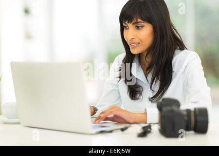 Pretty photographer working at laptop Stock Photo - Alamy