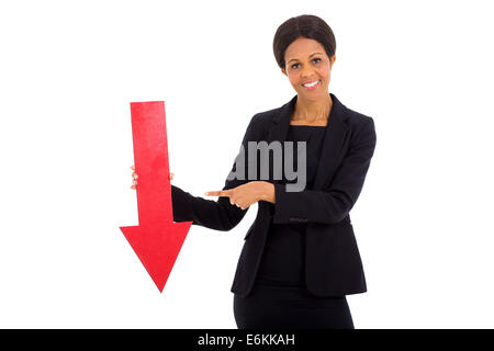 mature African businesswoman holding red arrow pointing down on white background Stock Photo