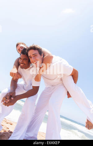 group of playful friends on beach Stock Photo