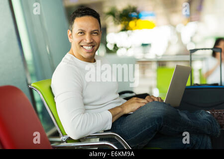 relaxed man using laptop at airport Stock Photo