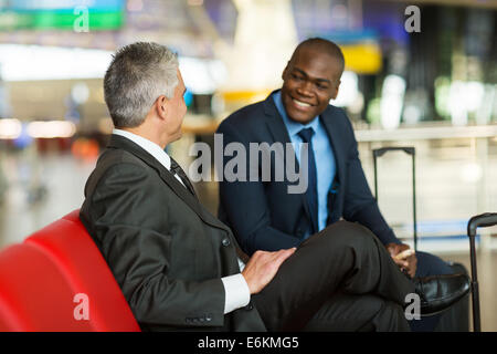 happy business partners waiting at airport lounge Stock Photo