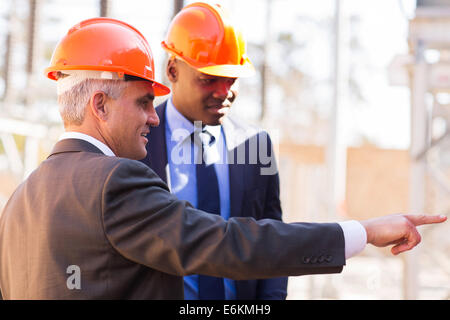 handsome inspectors working in electrical power station Stock Photo