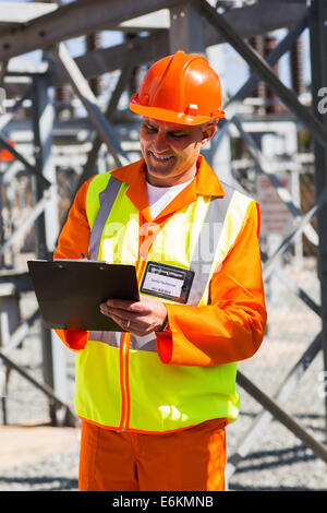 senior industrial technician taking readings in power plant Stock Photo