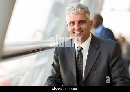 handsome middle aged businessman in modern office Stock Photo