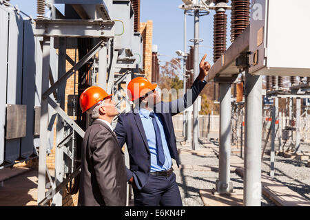 professional managers inspecting electricity power plant Stock Photo