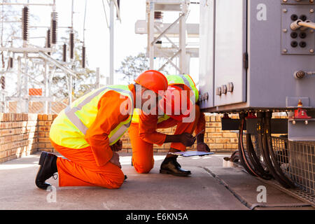 experienced electrical engineers working in substation Stock Photo
