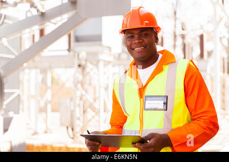 handsome male African electrical engineer in substation Stock Photo
