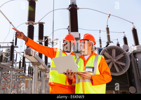 senior technician with co-worker working together in power plant Stock Photo