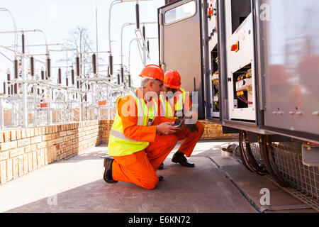 two electrical engineers discussing work in substation Stock Photo