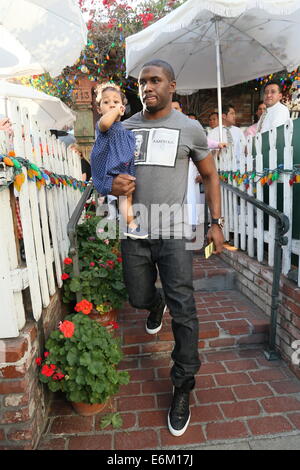 Reggie Bush and partner Lilit Avagyan with their daughter Briseis seen leaving the Ivy restaurant after having a late lunch.  Featuring: Reggie bush,Briseis Bush Where: Los Angeles, California, United States When: 20 Feb 2014 Stock Photo