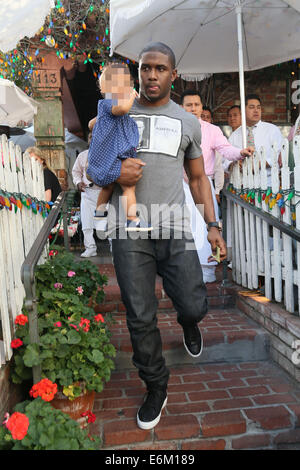 Reggie Bush and partner Lilit Avagyan with their daughter Briseis seen leaving the Ivy restaurant after having a late lunch.  Featuring: Reggie bush,Briseis Bush Where: Los Angeles, California, United States When: 20 Feb 2014 Stock Photo
