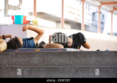 Sleeping Rough On A Pedestrian Overpass In North Point, Hong Kong. Stock Photo