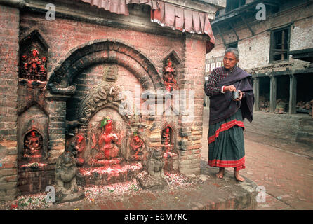 Newar woman worshipping a hindu deity ( Nepal) Stock Photo