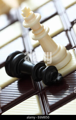 Defeat. Chess on the chocolate chessboard. Closeup. Stock Photo