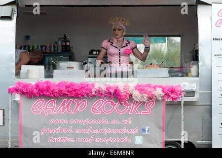 a man in drag sells food from camp cooks fast food stall at victorious festival 2014 southsea england uk Stock Photo