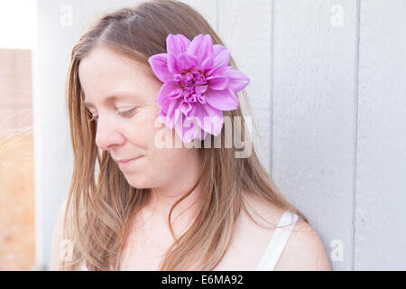 Portrait of woman with flower in hair Stock Photo
