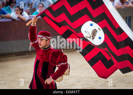 Man carrying a flag from the little owl contrade, historical parade before the Palio di Siena horse race, Siena, Tuscany, Italy Stock Photo