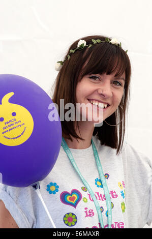 young staff member smiling at her charity stall at the victorious festival 2014 southsea england uk Stock Photo