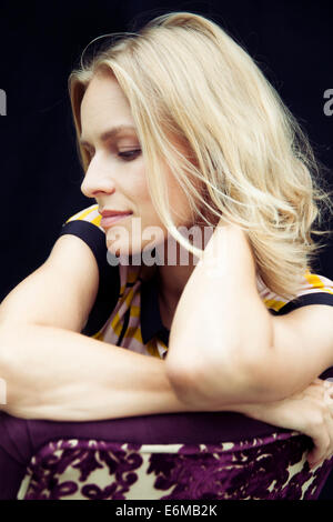 Portrait of woman sitting on chair Stock Photo