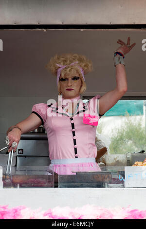 a man in drag sells food from camp cooks fast food stall at victorious festival 2014 southsea england uk Stock Photo