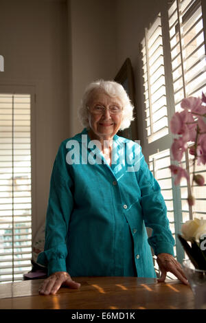 Portrait of elderly woman in bedroom Stock Photo