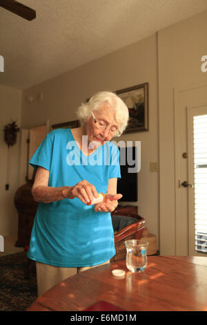 Elderly woman taking medication Stock Photo
