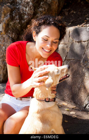 Woman with dog in backyard Stock Photo