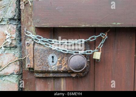 Rusty door lock with additonal chain Stock Photo