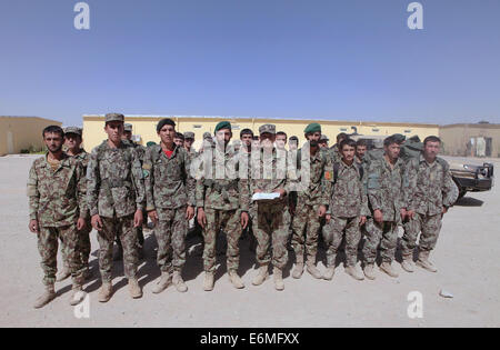 Afghan National Army soldiers with the 215th Corps in formation following a graduation ceremony August 20, 2014 in Camp Shorabak, Helmand province, Afghanistan. More than 30 soldiers graduated a six-week instructor training course that covered advanced weapons, skills instruction and teaching basics. The graduation was significant because it was the first instructor training course completely operated by Afghan instructors without any help from coalition forces. Stock Photo